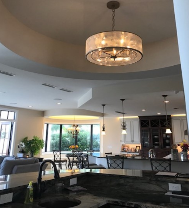Open-concept kitchen with island and chandelier