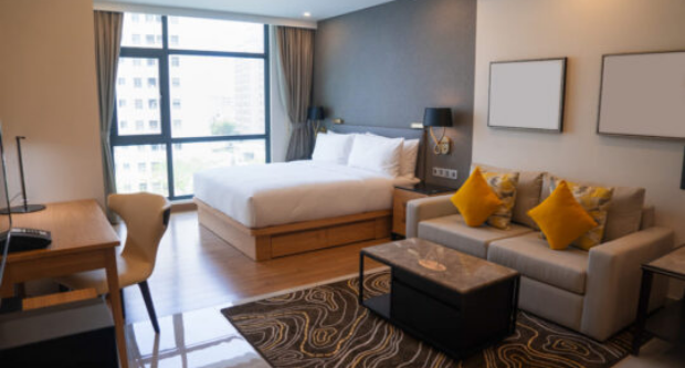 Modern hotel room with bed and sofa