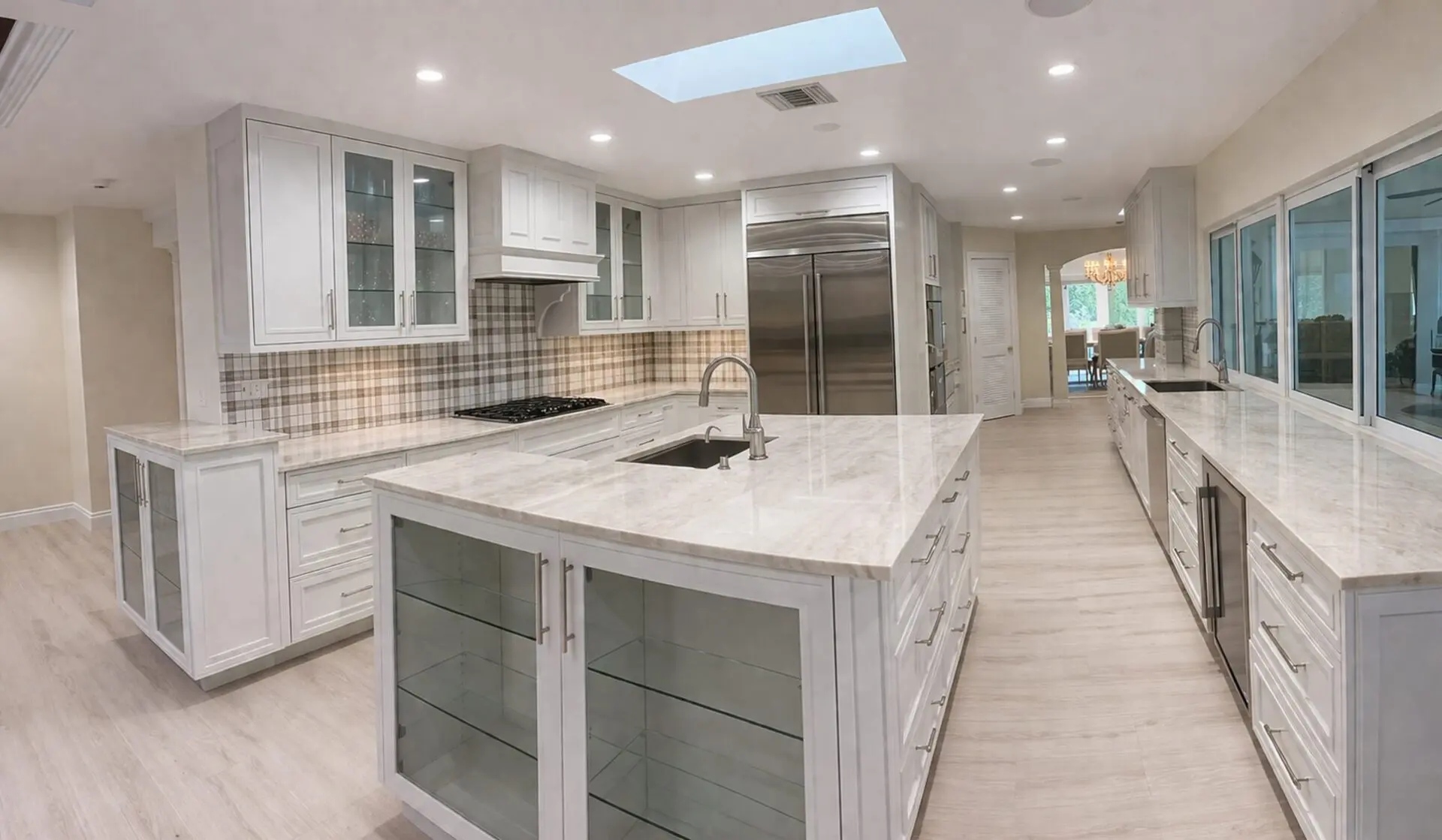 Spacious modern white kitchen with marble island
