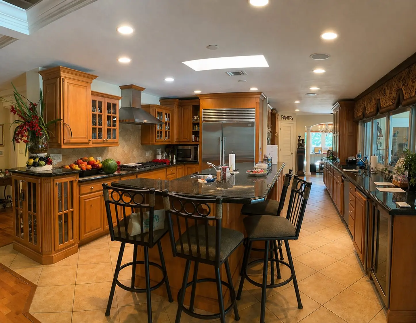 Spacious kitchen with island and bar stools