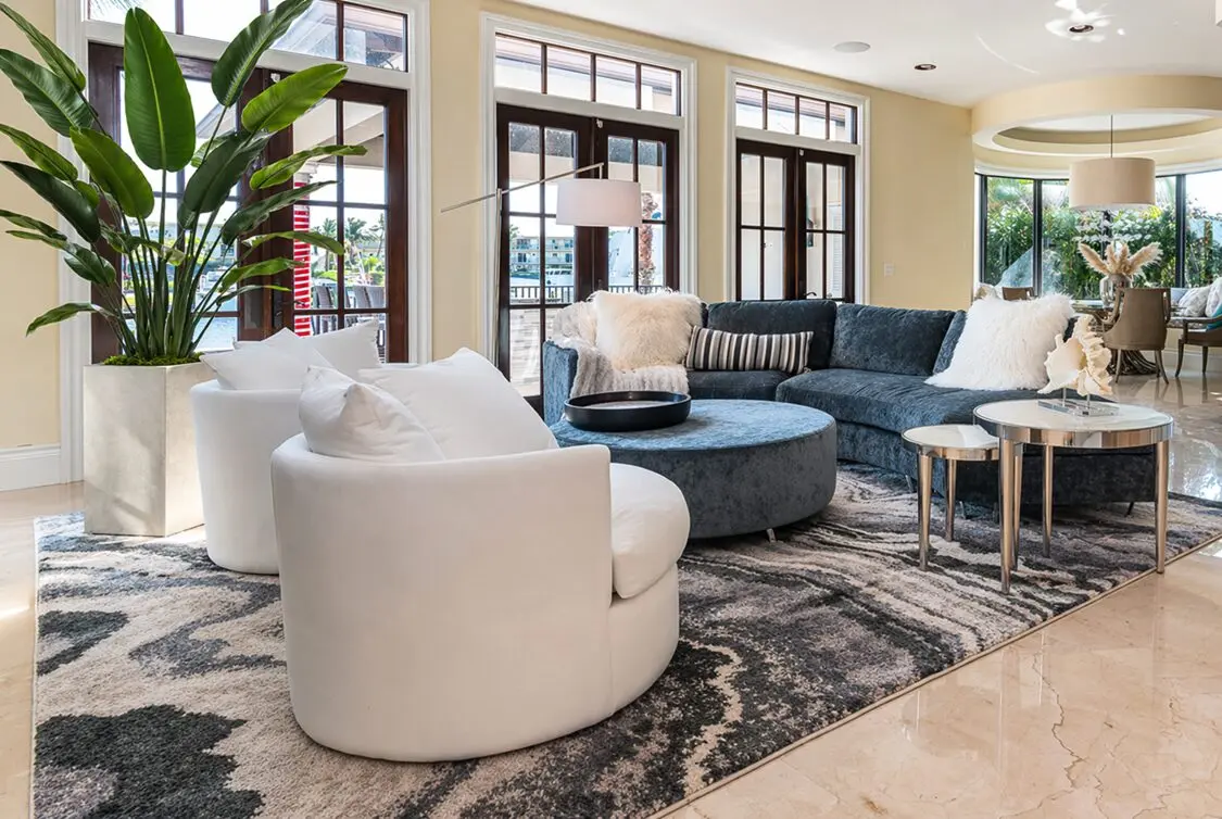 High-end coastal living room interior with modern luxury furnishings and custom designer details.